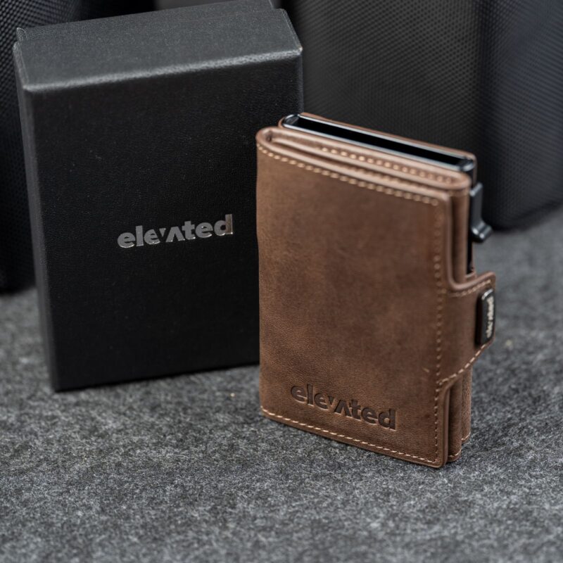 Kaarditasku Elevated Snap 1.0 Chocolate Brown, musta kinkekarbi kõrval